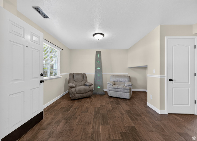 802 Sugar Maple Court Payson, UT 84651 - Photo 9 of 30 Living area featuring dark wood finished floors and a textured ceiling