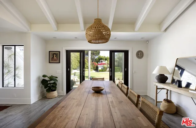 a very nice looking room with wooden floor and a large window