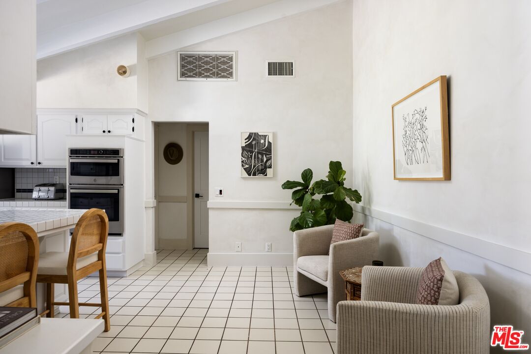 29328 Heathercliff Road Malibu, CA 90265 - Photo 12 of 41 a living room with furniture a white wall and next to a window