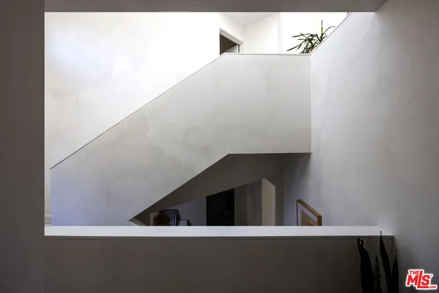 a bedroom with a large bed and a large window with outer view