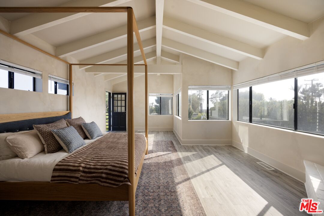 29328 Heathercliff Road Malibu, CA 90265 - Photo 18 of 41 a bedroom with a large bed and a large window with outer view