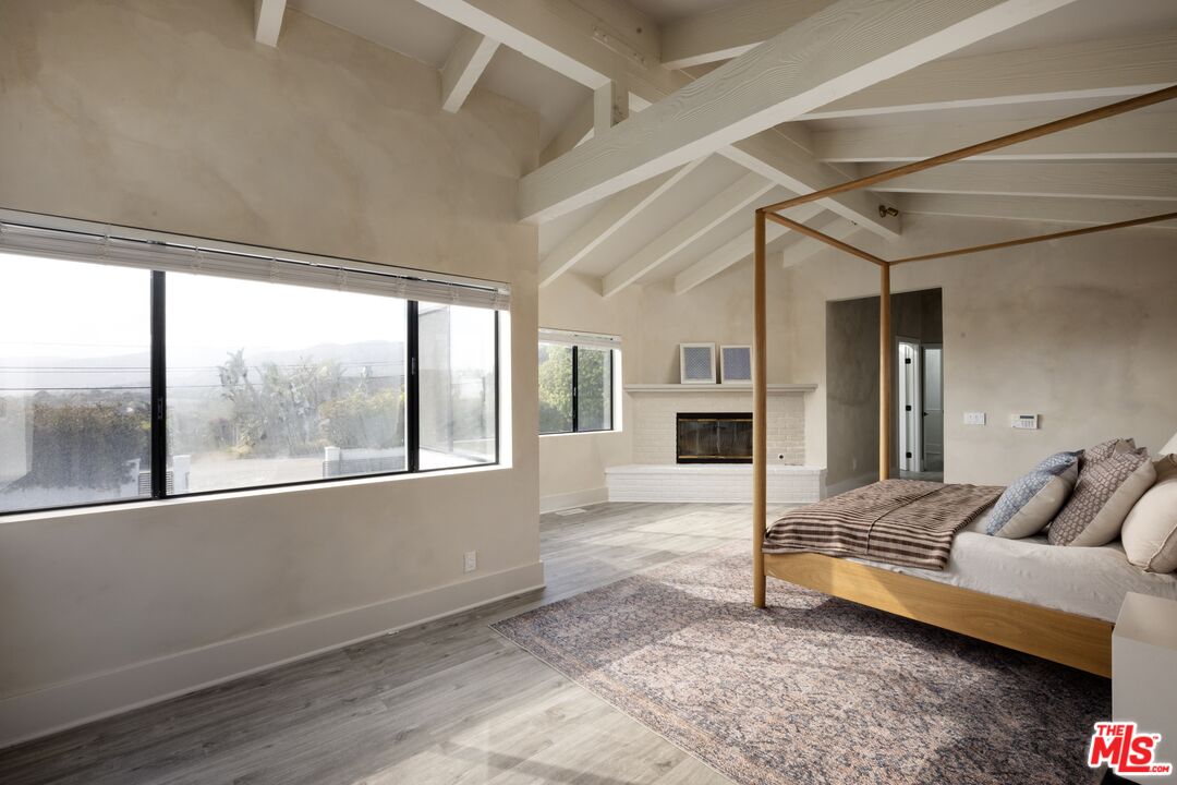 29328 Heathercliff Road Malibu, CA 90265 - Photo 20 of 41 a living room with furniture and a fireplace