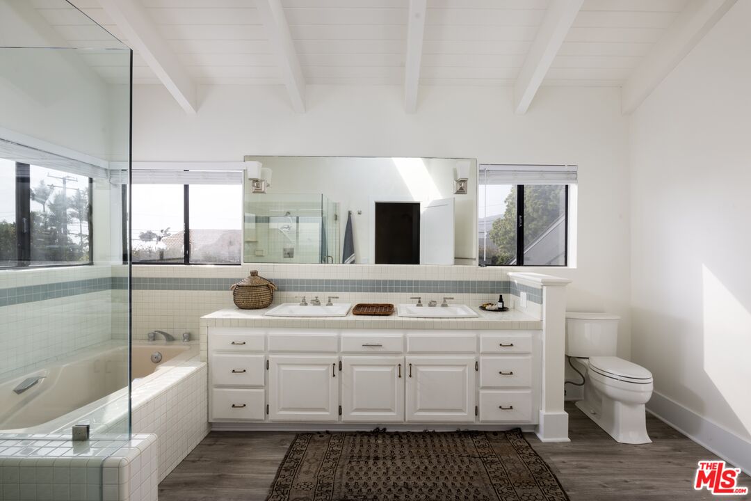 29328 Heathercliff Road Malibu, CA 90265 - Photo 21 of 41 a spacious bathroom with a double vanity sink mirror and toilet