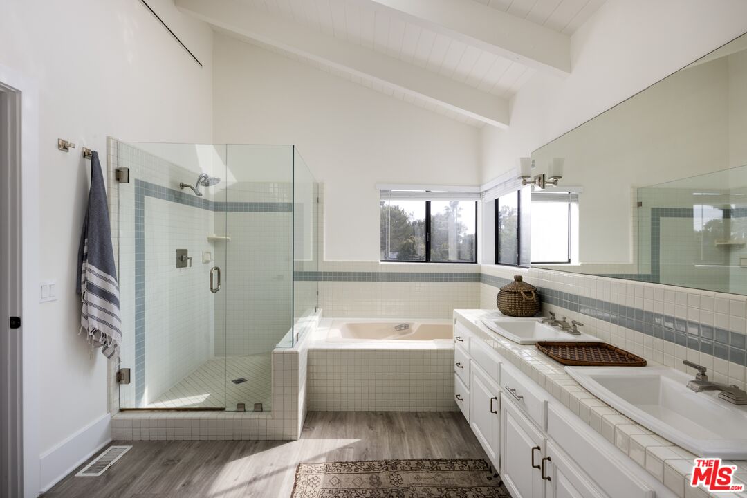 29328 Heathercliff Road Malibu, CA 90265 - Photo 22 of 41 a bathroom with a tub sink and mirror