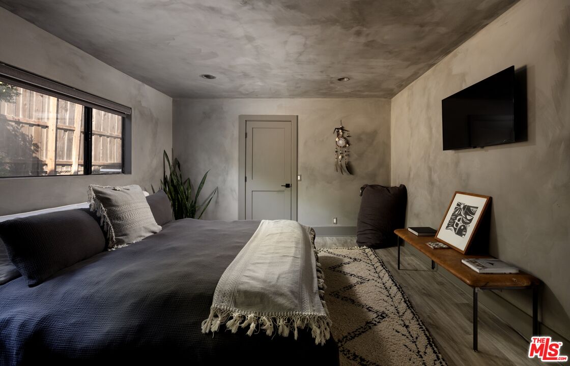 29328 Heathercliff Road Malibu, CA 90265 - Photo 23 of 41 a bedroom with a bed and tv