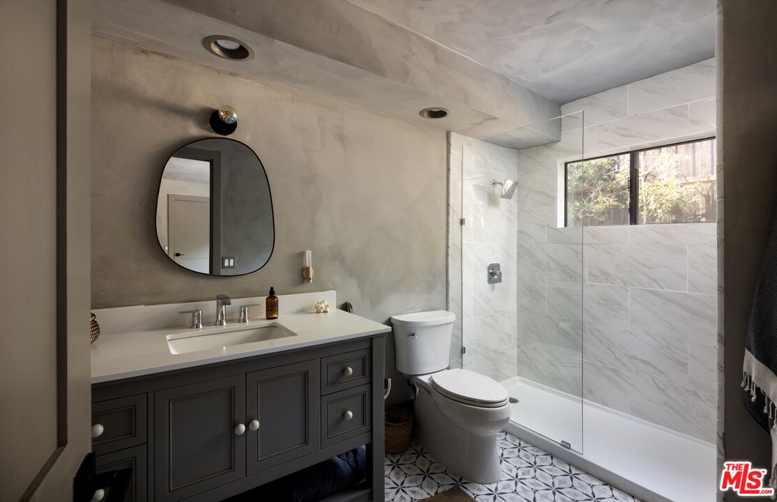 29328 Heathercliff Road Malibu, CA 90265 - Photo 24 of 41 a bathroom with a toilet sink double vanity and mirror