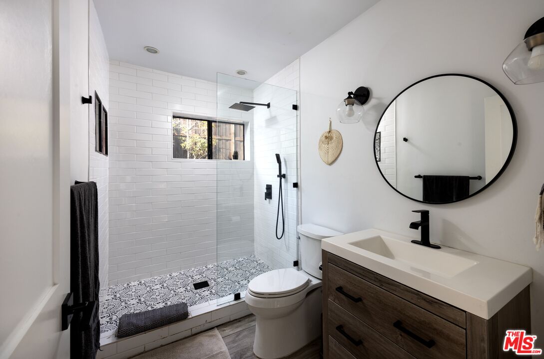 29328 Heathercliff Road Malibu, CA 90265 - Photo 26 of 41 a bathroom with a sink a toilet and shower