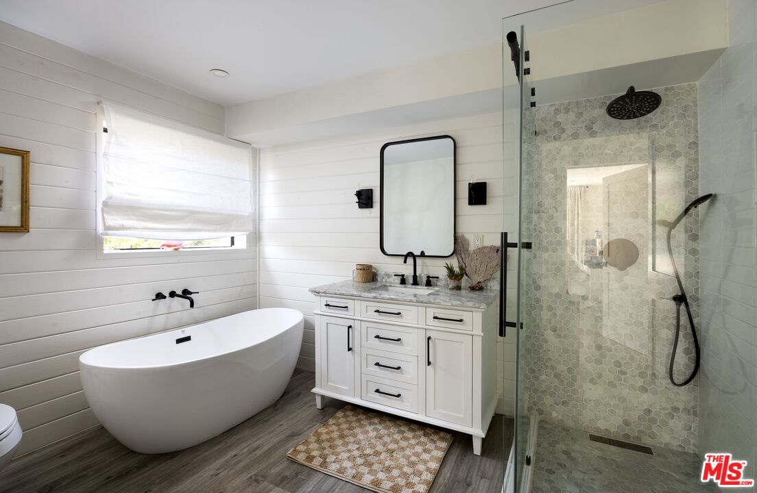 29328 Heathercliff Road Malibu, CA 90265 - Photo 28 of 41 a bathroom with a double vanity sink mirror and bathtub