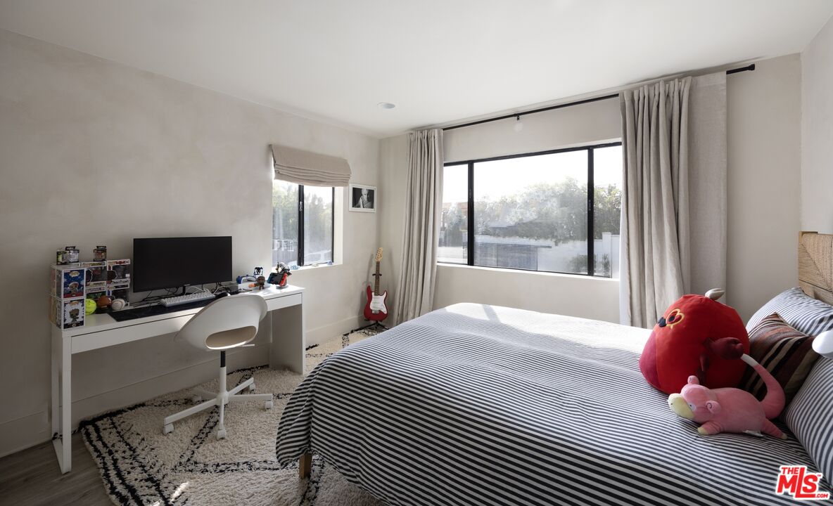 29328 Heathercliff Road Malibu, CA 90265 - Photo 29 of 41 a bedroom with a bed and a flat screen tv