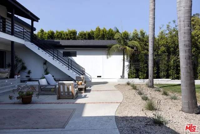 a view of a chairs and table in backyard
