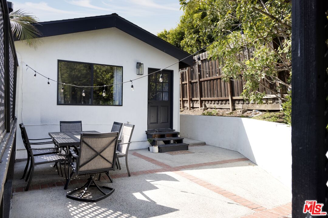 29328 Heathercliff Road Malibu, CA 90265 - Photo 32 of 41 a view of a chairs and table in backyard