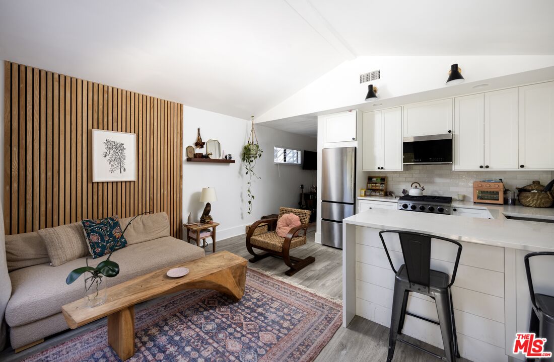 29328 Heathercliff Road Malibu, CA 90265 - Photo 33 of 41 a living room with furniture and a flat screen tv