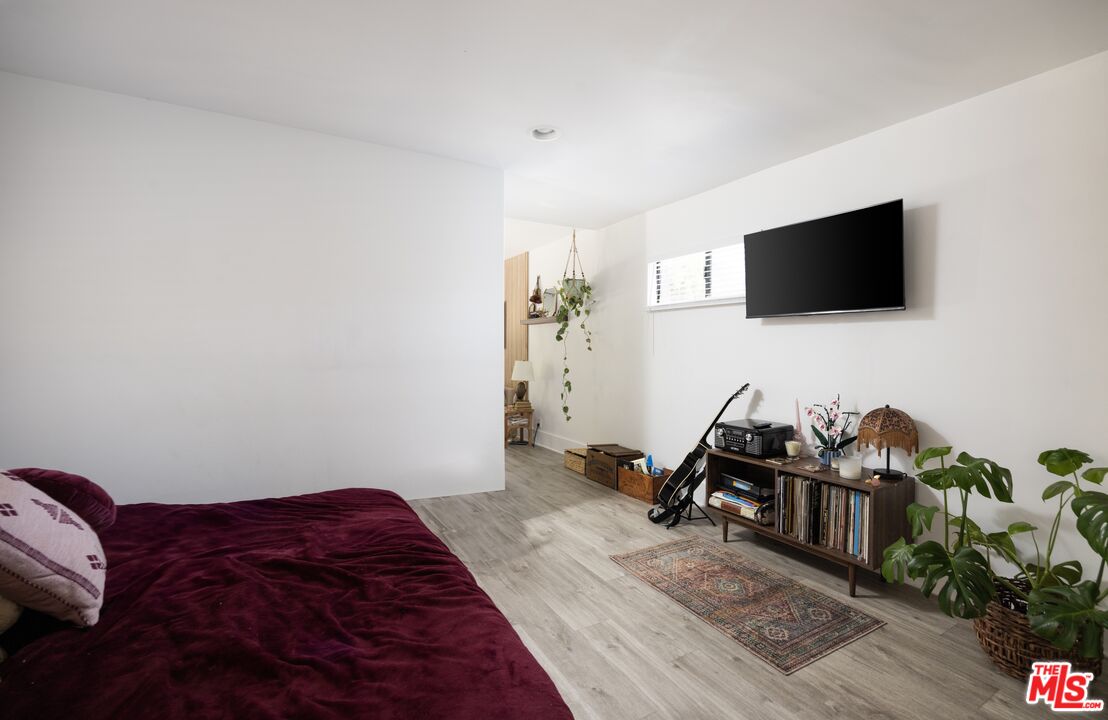 29328 Heathercliff Road Malibu, CA 90265 - Photo 35 of 41 a bedroom with a bed and a flat screen tv