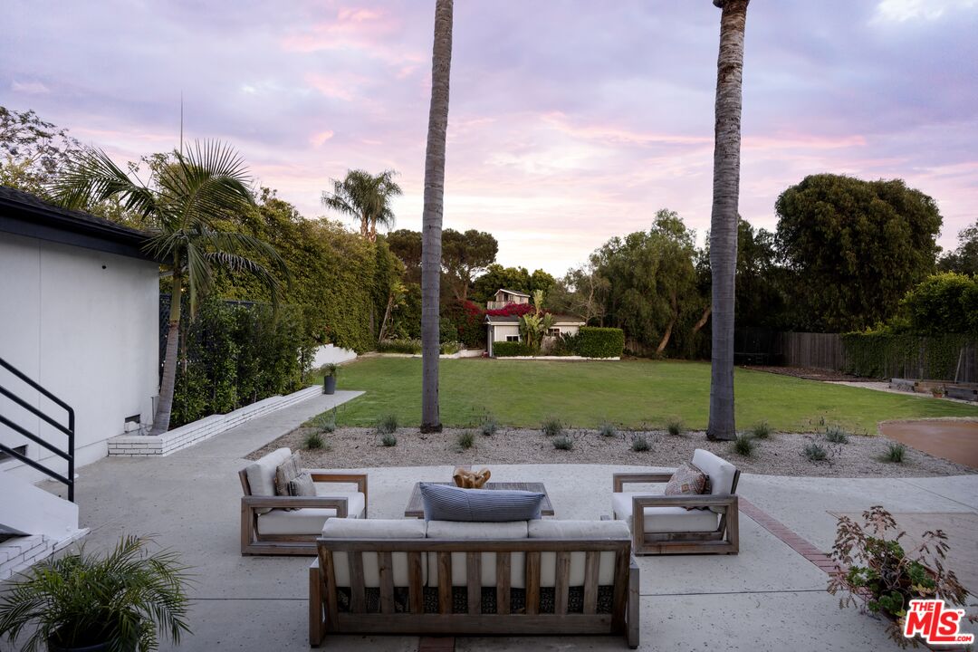 29328 Heathercliff Road Malibu, CA 90265 - Photo 36 of 41 a view of a patio with couches chairs and a fire pit