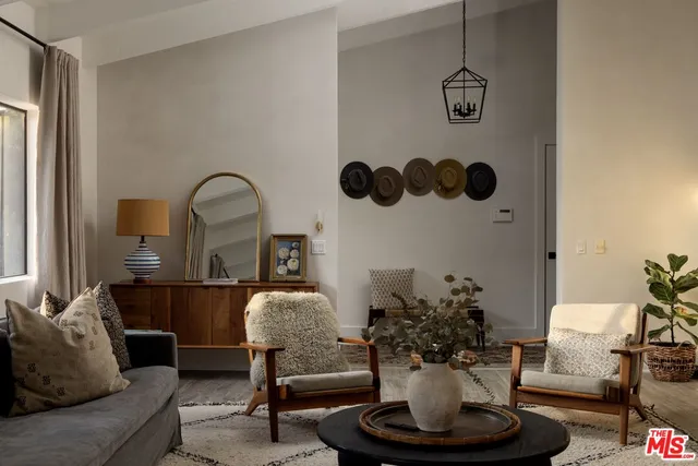 a living room with furniture flowerpot and a window