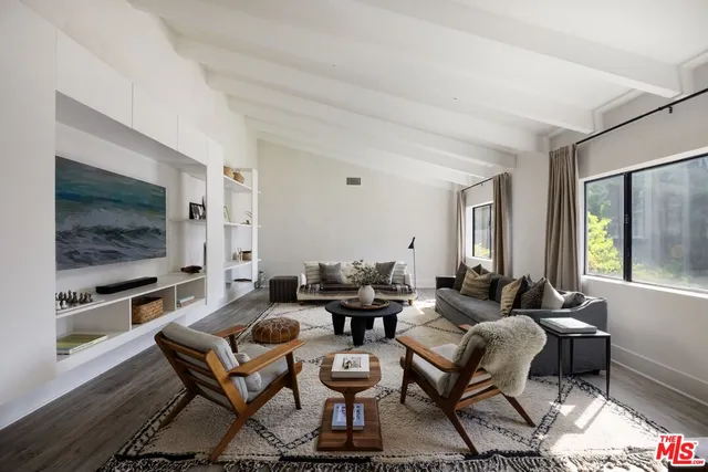 a living room with fireplace furniture and a flat screen tv