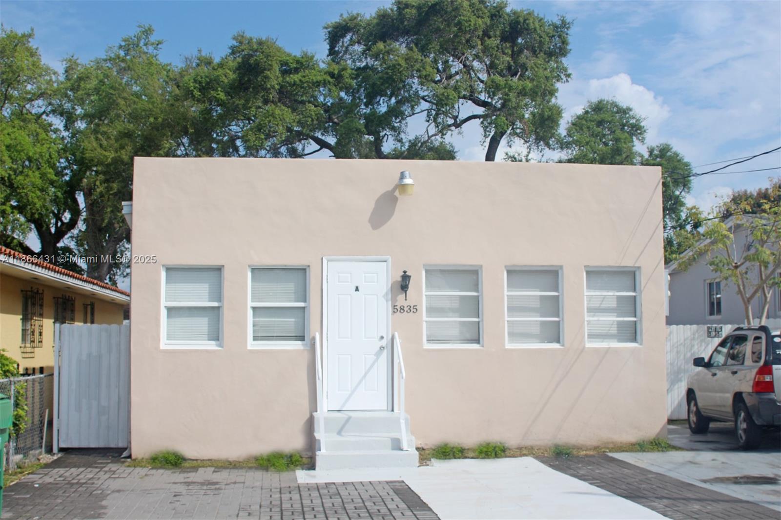 5835 Southwest 4th Street, Unit C Miami, FL 33144 - Photo 1 of 1 a view of a building with a garden