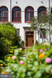 a front view of house with yard and trees in the background