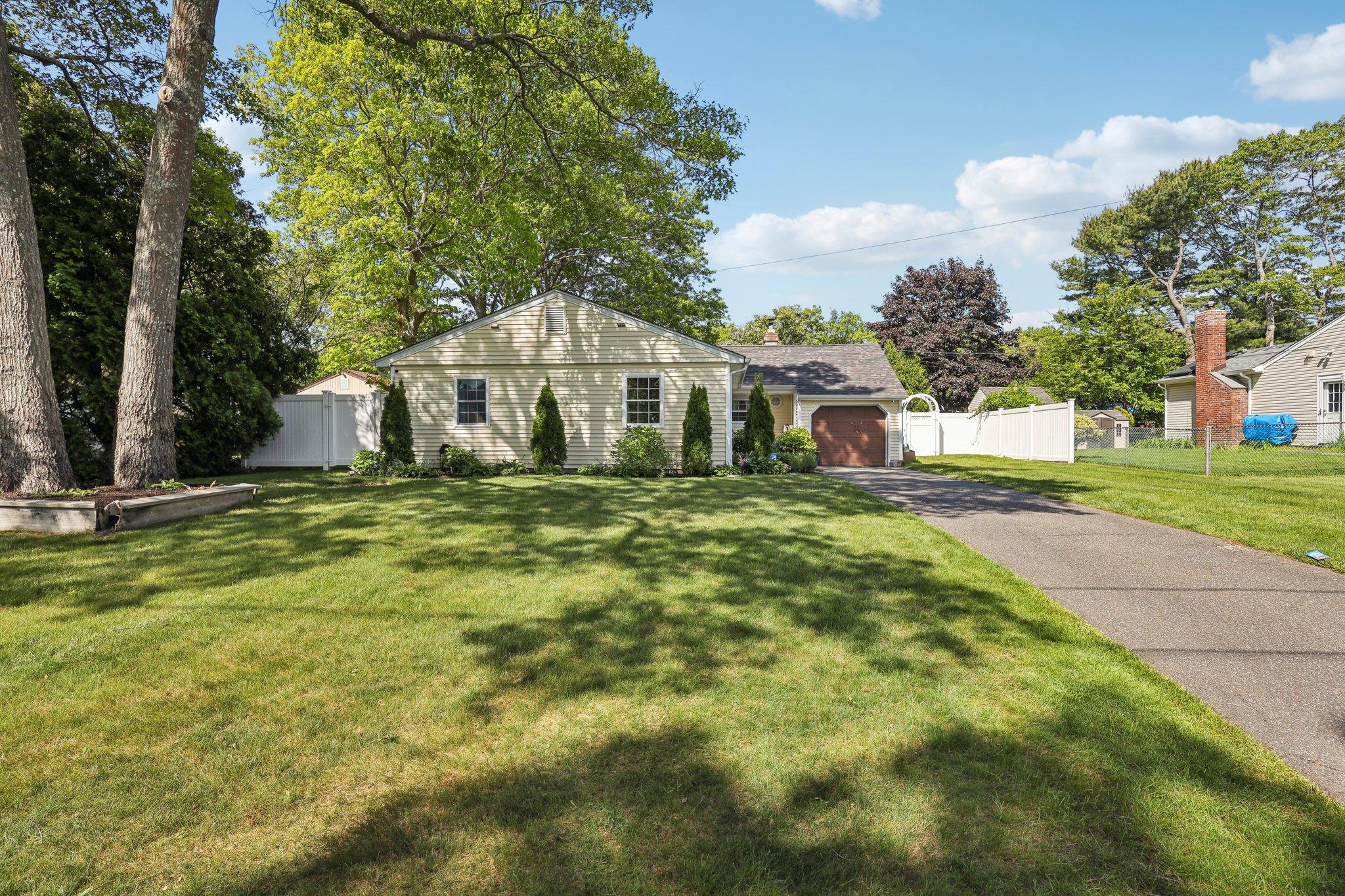 a front view of a house with a garden