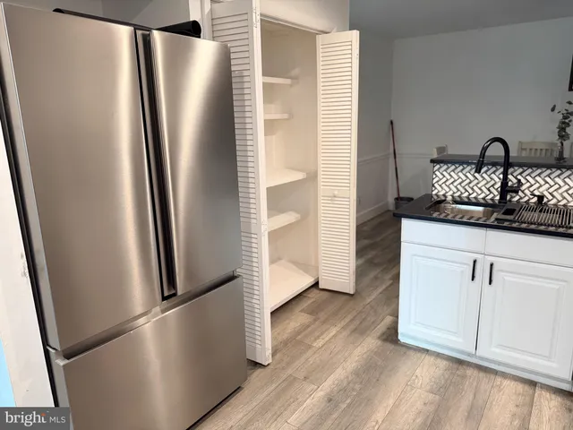a kitchen with stainless steel appliances granite countertop a refrigerator and a stove