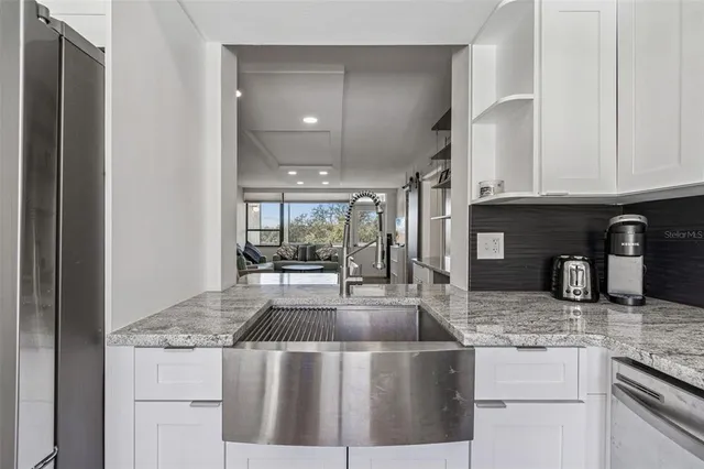 a kitchen with a table chairs refrigerator and microwave