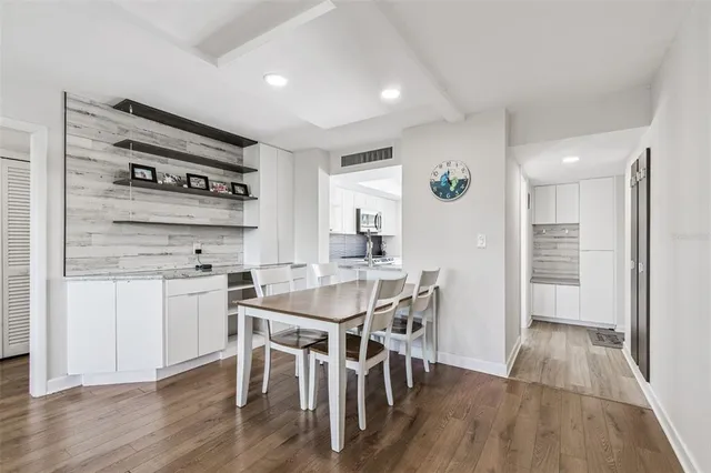 a living room with furniture and a book shelf