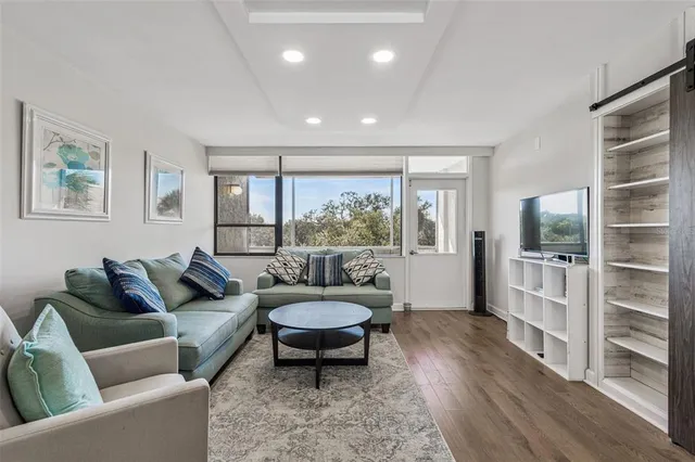 a view of a livingroom with a ceiling fan and window