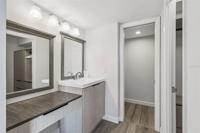 a large kitchen with stainless steel appliances granite countertop a lot of counter space and wooden floor