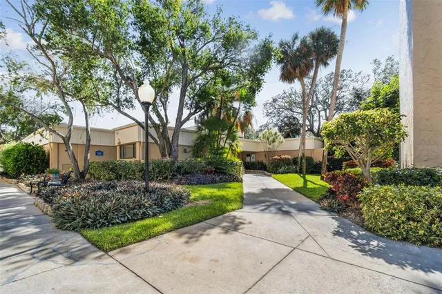 a view of a swimming pool with a patio and a yard