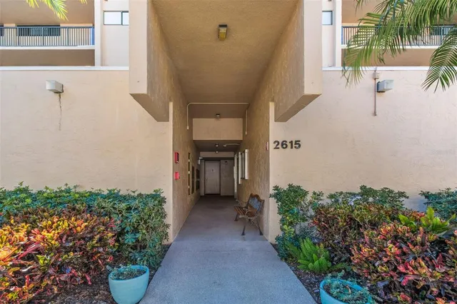 a kitchen with a refrigerator stove and white cabinets with wooden floor