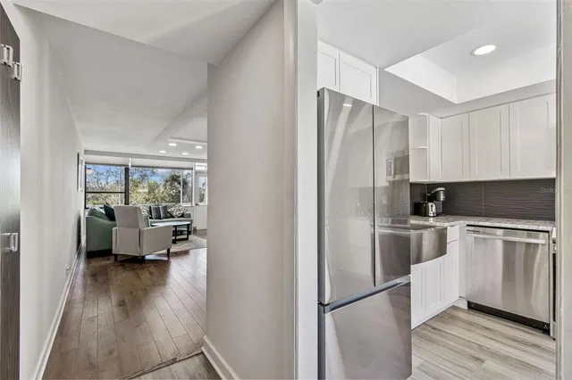 a kitchen with stainless steel appliances granite countertop a stove microwave and sink
