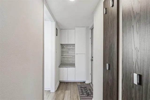 a kitchen with refrigerator and cabinets