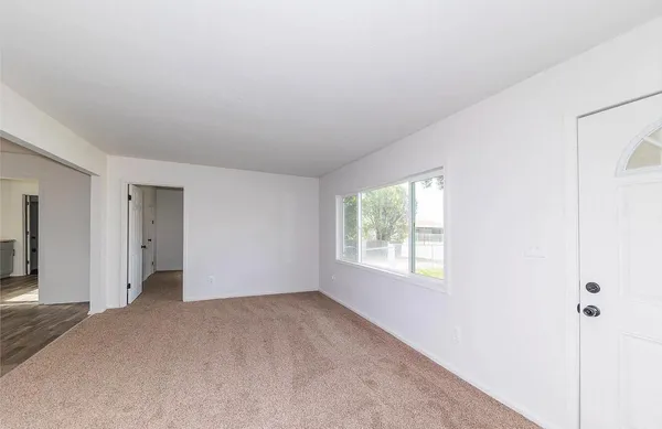 a view of an empty room with a window