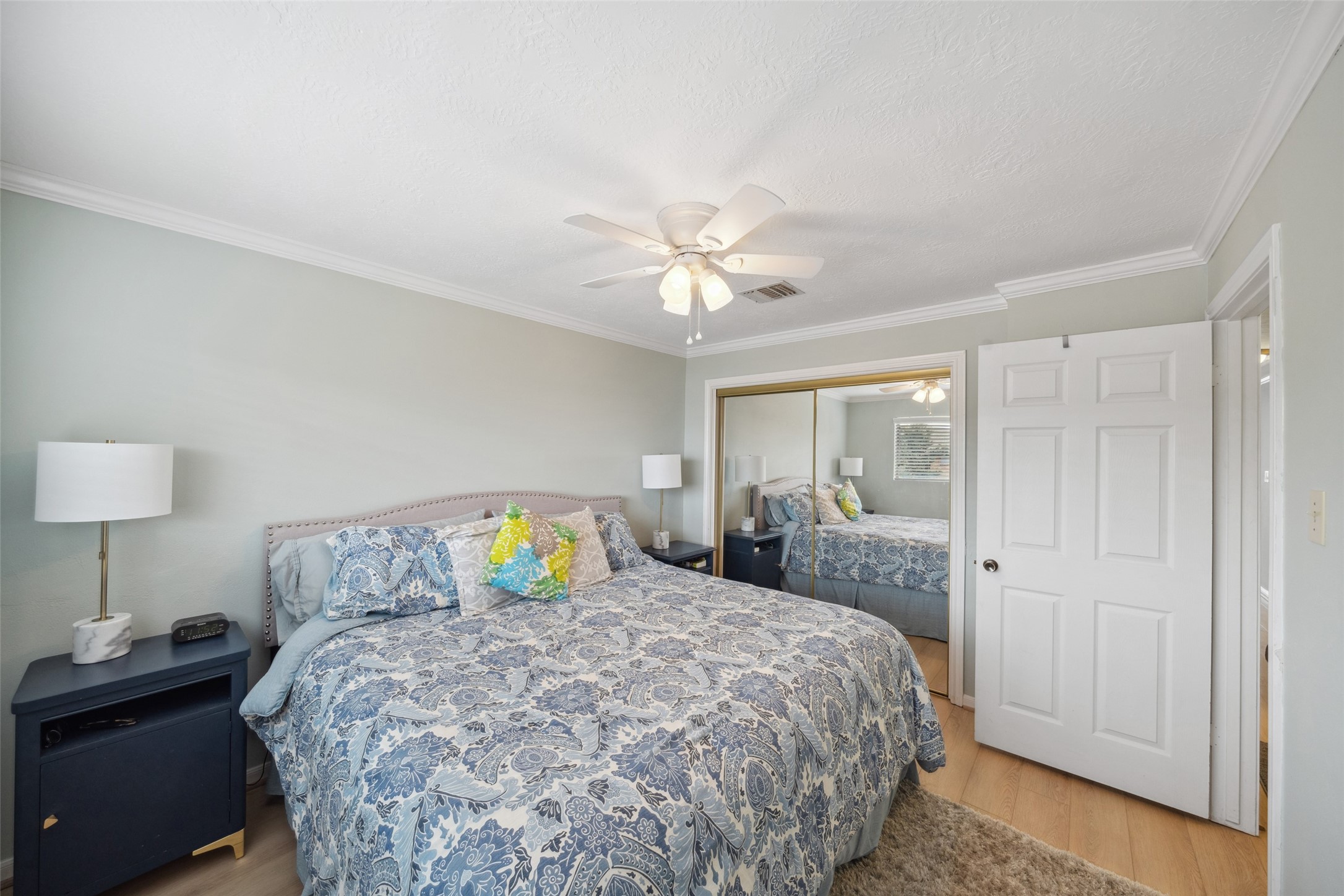 801 River Road, Unit F120 Montgomery, TX 77356 - Photo 15 of 18 a bedroom with a bed and a lamp on dresser