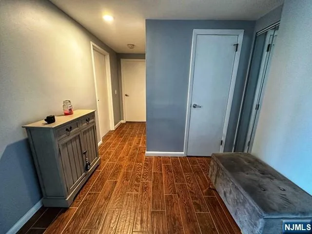 a view of hallway with wooden floor