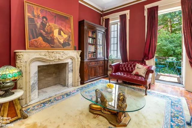 a living room with furniture a fireplace and a floor to ceiling window