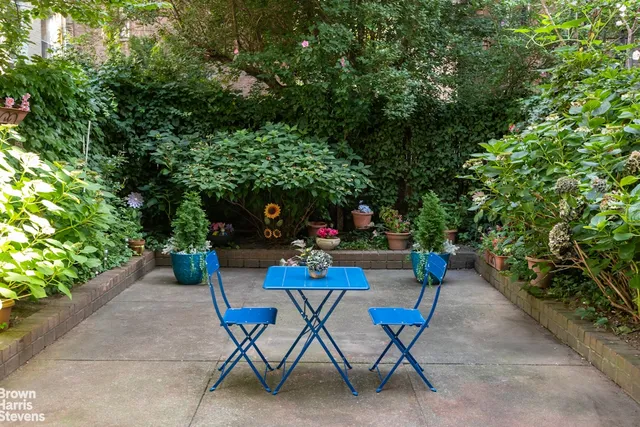 a view of a chairs and table in backyard