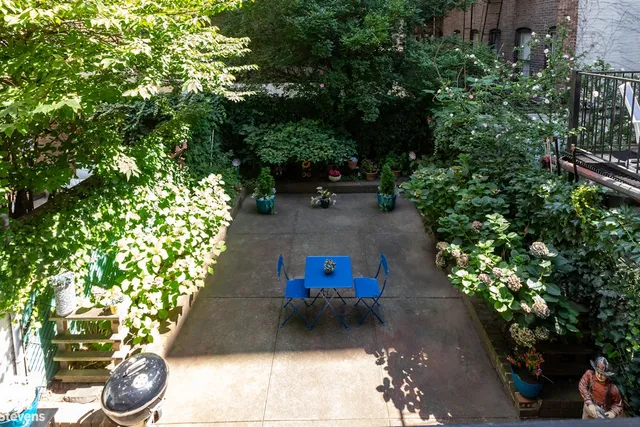 a swimming pool with trees in the backyard