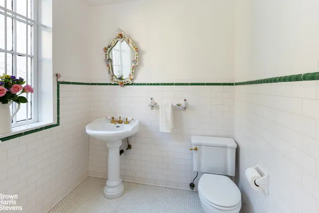 a bathroom with a sink a toilet and a mirror