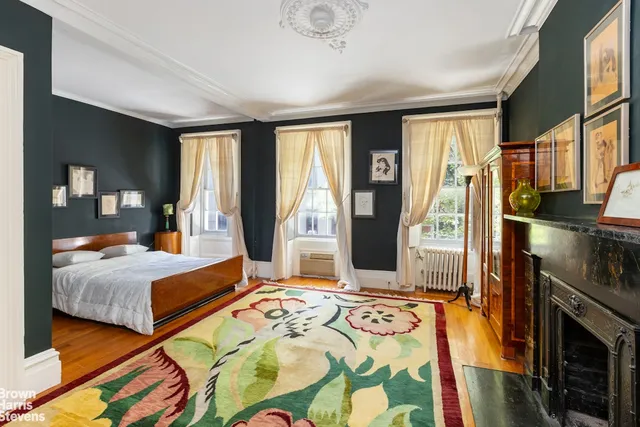 a bedroom with a large bed and a flat tv screen