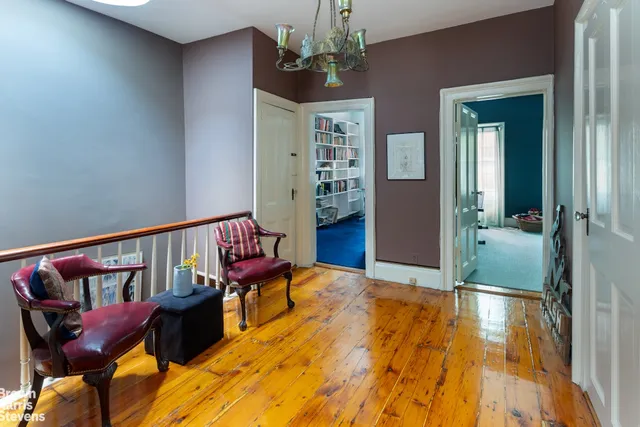 a view of a balcony with furniture and wooden floor