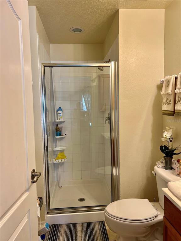 232 Cape Harbour Loop, Unit 101 Bradenton, FL 34212 - Photo 11 of 16 a bathroom with a glass shower door