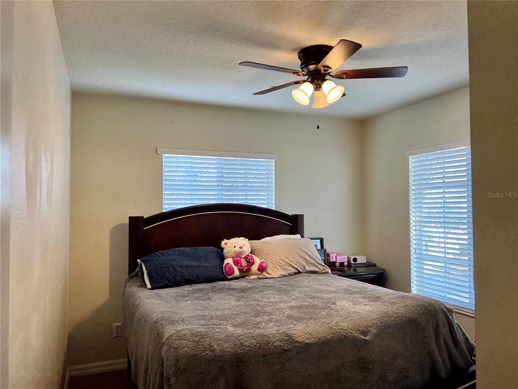 232 Cape Harbour Loop, Unit 101 Bradenton, FL 34212 - Photo 12 of 16 a bedroom with a bed and a chandelier