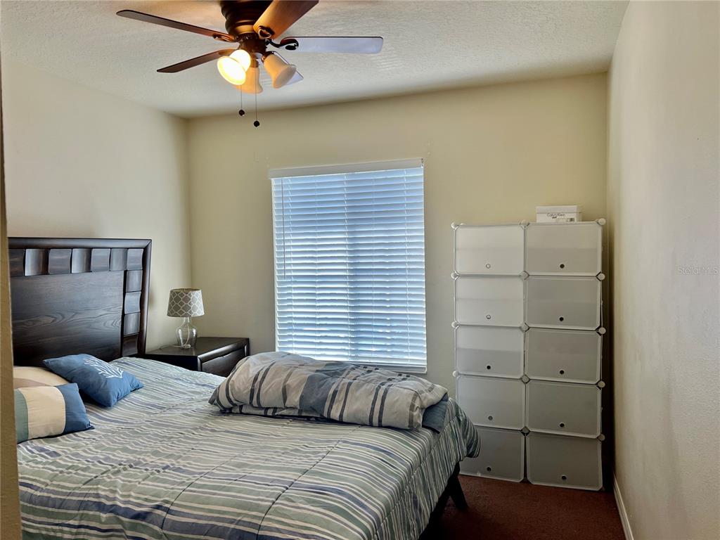232 Cape Harbour Loop, Unit 101 Bradenton, FL 34212 - Photo 14 of 16 a bedroom with a large bed and a chandelier