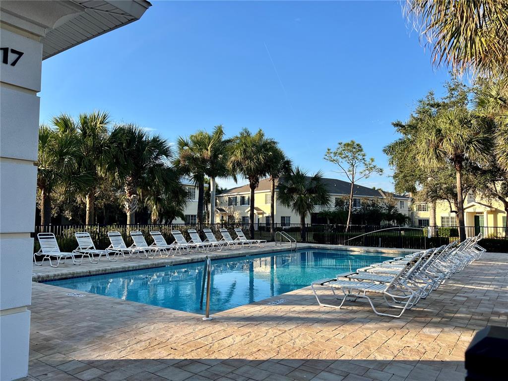232 Cape Harbour Loop, Unit 101 Bradenton, FL 34212 - Photo 16 of 16 a view of a swimming pool with a lounge chairs