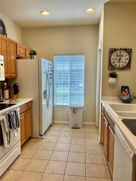 232 Cape Harbour Loop, Unit 101 Bradenton, FL 34212 - Photo 3 of 16 a kitchen with a sink a stove and a refrigerator