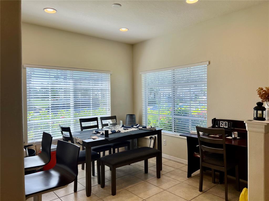 232 Cape Harbour Loop, Unit 101 Bradenton, FL 34212 - Photo 5 of 16 a view of a dining room with furniture and windows