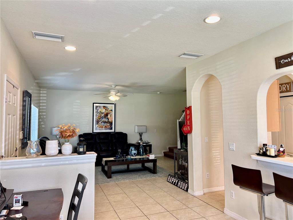 232 Cape Harbour Loop, Unit 101 Bradenton, FL 34212 - Photo 7 of 16 a living room with furniture and a flat screen tv