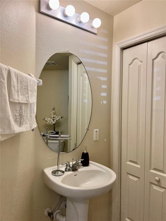 232 Cape Harbour Loop, Unit 101 Bradenton, FL 34212 - Photo 8 of 16 a bathroom with a sink and a mirror