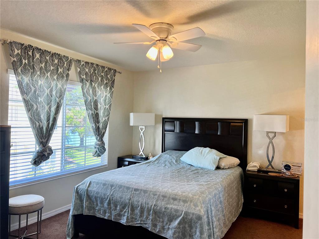 232 Cape Harbour Loop, Unit 101 Bradenton, FL 34212 - Photo 10 of 16 a bedroom with a bed and a chandelier